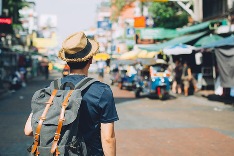 A travel blogger in an exotic locale. Photo courtesy of Shutterstock